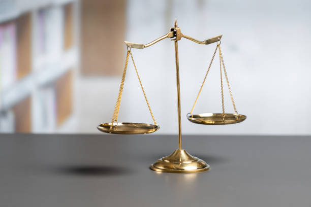 istock Shiny golden scale balance in library background as justice symbol. equility 1483001390