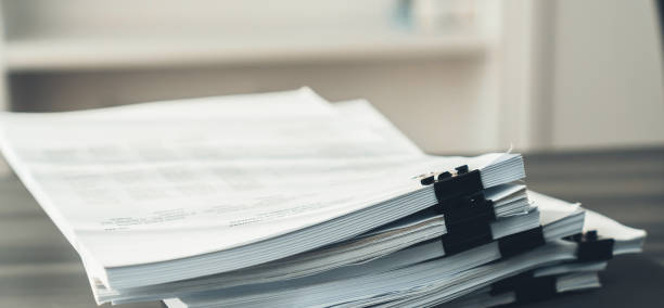 istock Closeup office table with organized stacked papers. equility 1483001533