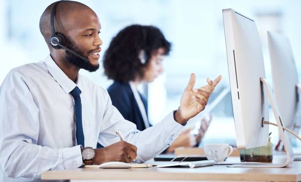 istock Call center, business and black man with computer, telemarketing or talking to help with tech support. Corporate, African American male employee or consultant with headset, conversation and workplace 1483002085