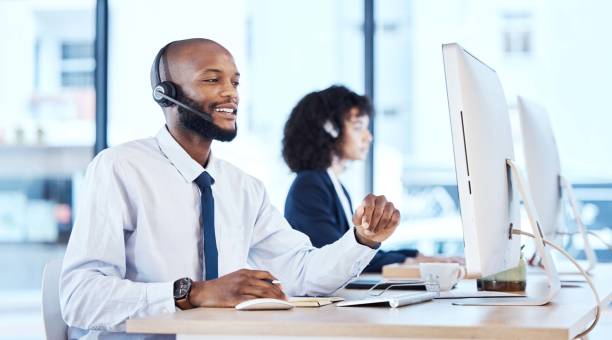 istock Callcenter, customer service or black man on computer for customer support, consulting or networking in office. Manager, CRM or sales advisor on tech for telemarketing, research or contact us help 1483002086