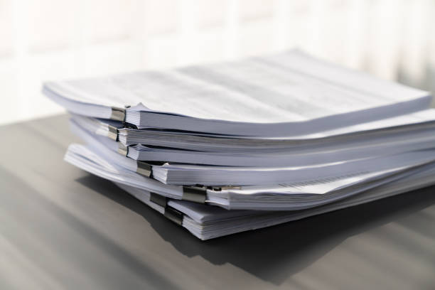 istock Closeup office table with organized stacked papers. equility 1483002195