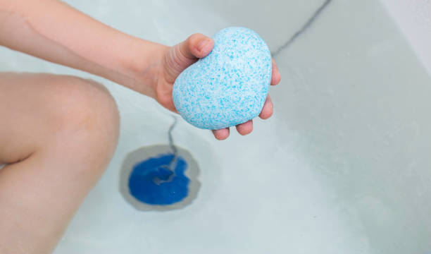 istock A child in the bath is holding a blue bath bomb with coconut extract. Copy space for text 1483004751