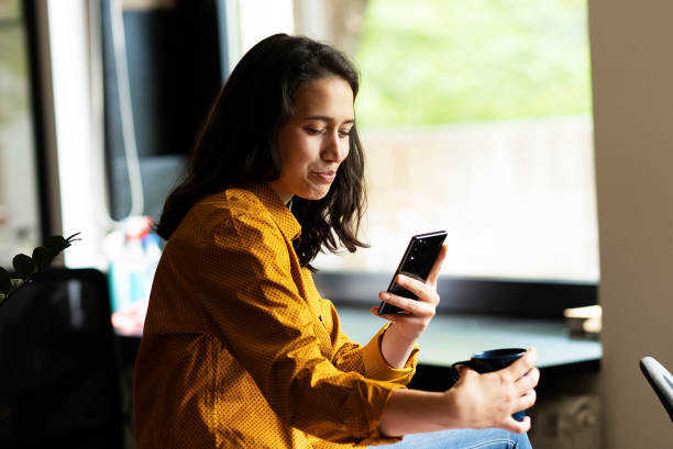 istock Young businesswoman drinking coffee in her office. 1483004797