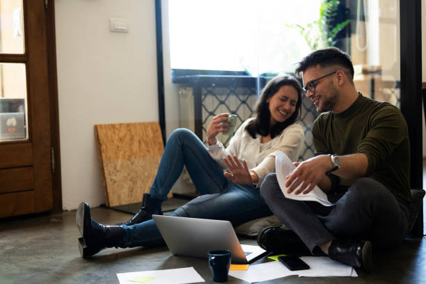 istock Colleagues sitting on the floor in office 1483005560