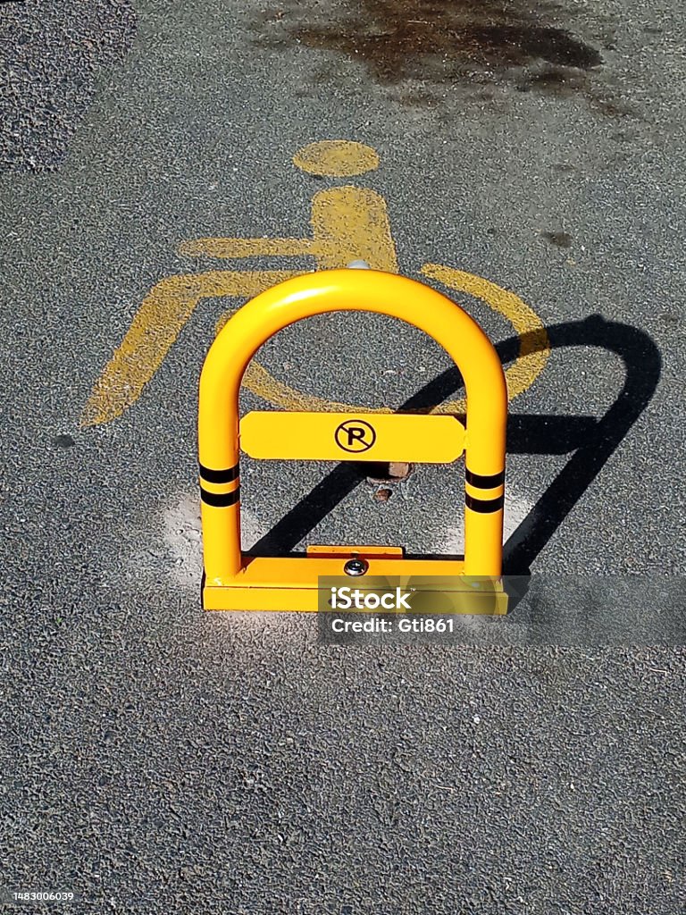 Private parking Parking lot for disabled people with metal barrier. Accessibility Sign Stock Photo