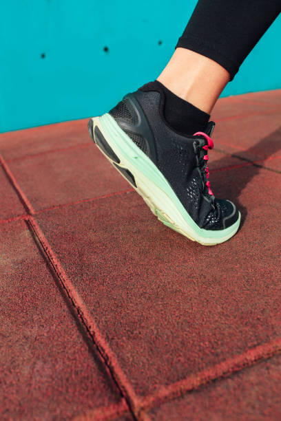 Athlete runner foot, closeup on shoe. Athlete runner foot, closeup on shoe with copy space legs against the wall stock pictures, royalty-free photos & images