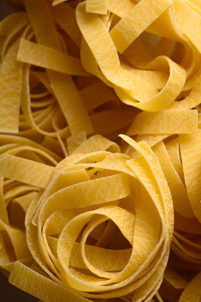 Fettuccine pasta noodle food ingredient on black background