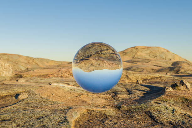 istock single glas sphere ball hovering in the air in large empty desert environment; abstract surreal concept; 3D Illustration 1483009351