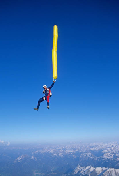 istock Skydiver in free fall with colourful streamer 1483010199