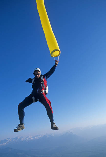 istock Skydiver in free fall with colourful streamer 1483010208