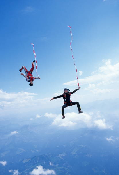 istock Skydivers in free fall with colourful streamers 1483010240