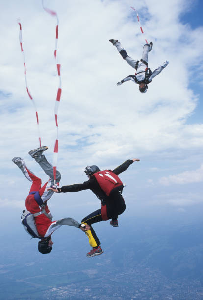 istock Skydivers in free fall with colourful streamers 1483010243