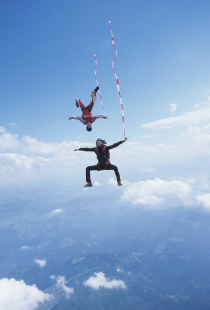 istock Skydivers in free fall with colourful streamers 1483010245