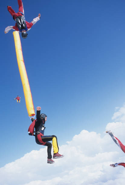 istock Skydivers in free fall with colourful streamers 1483010251
