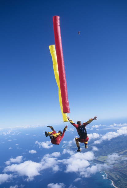 istock Skydivers in free fall with colourful streamers 1483010274