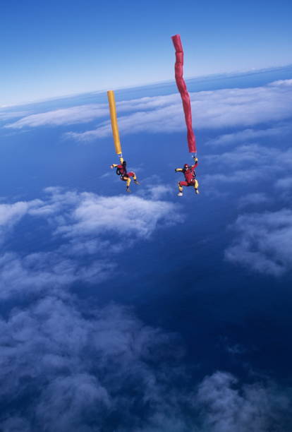 istock Skydivers in free fall with colourful streamers 1483010290