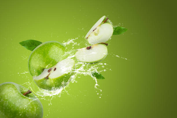 istock Creative layout made from Green Apple and water splashing on a green background. 1483010605
