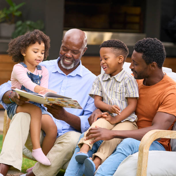 istock Smiling Multi-Generation Family Reading Book In Garden Together 1483011906