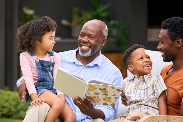 istock Smiling Multi-Generation Family Reading Book In Garden Together 1483012104