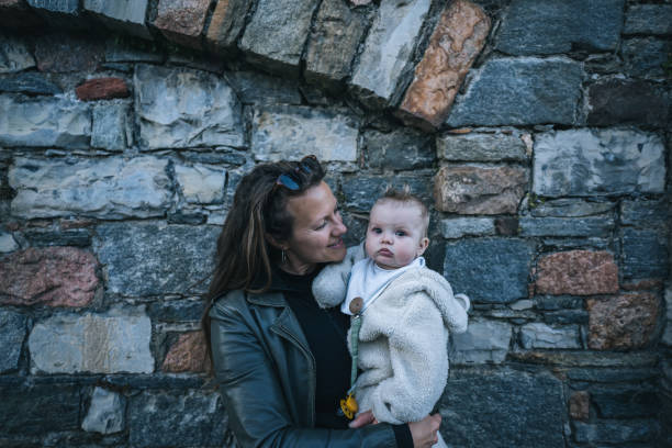 istock Mother and infant pause by old wall 1483013450