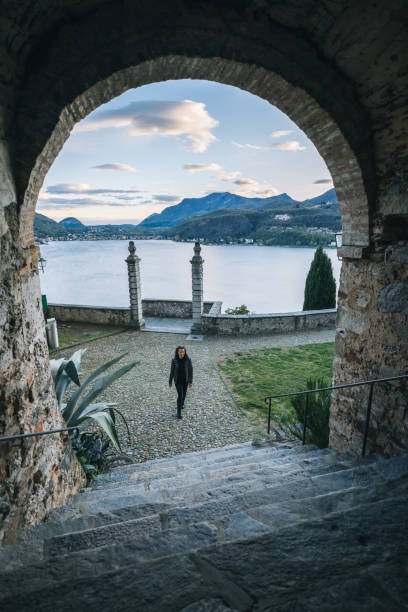 istock Woman walks under stone archway 1483013946