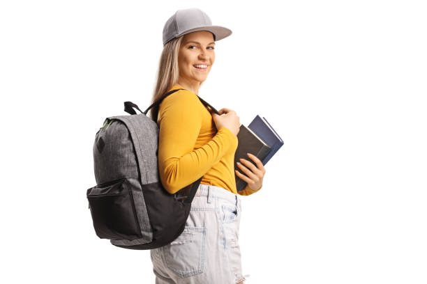 istock Female student with a backpack looking over shoulder and holding books 1483014102