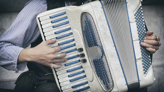 Close Up Shot Of A Man Playing The Accordion On The Street