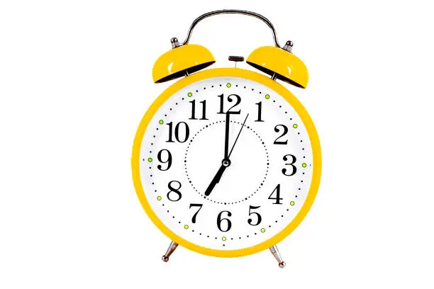 Photo of Yellow alarm clock isolated on the white background