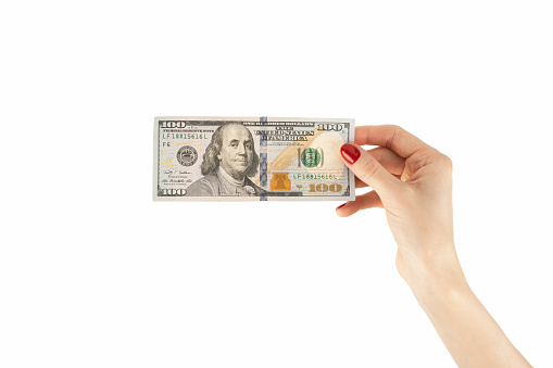 Female hand holds american dollars money. Finance, earnings, crediting. High quality photo