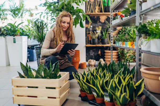 istock The botanist in the flower shop uses a digital tablet while doing the inventory 1483017798
