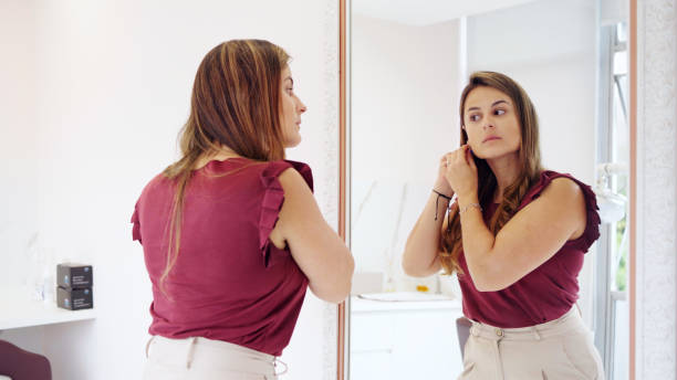 istock Young dentist getting ready for the workday in an office mirror 1483018656