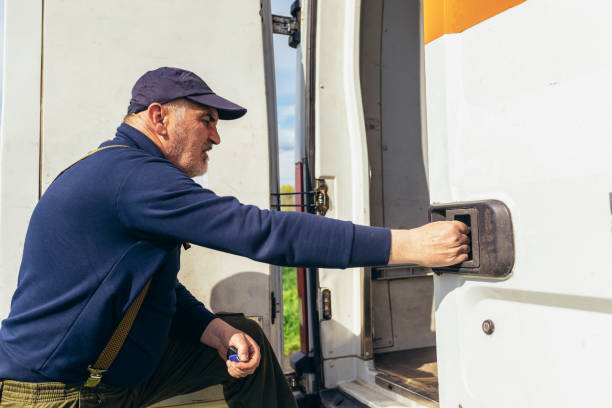 istock Mature van driver gets into his delivery van to check on the delivery. 1483021993