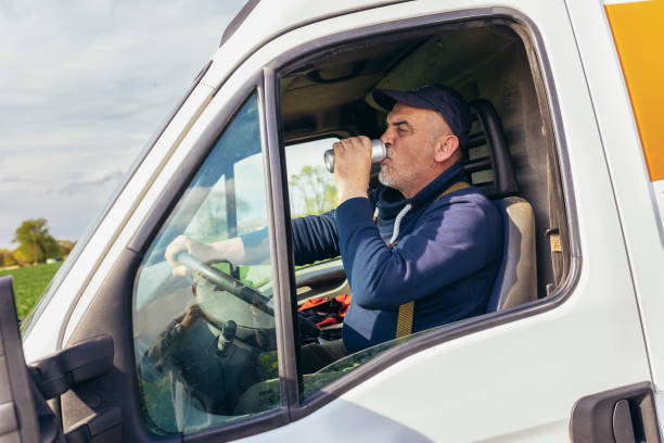 istock Truck driver drinks canned juice while sitting in the white cargo van vehicle 1483022138