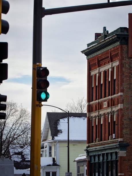 istock Modern building stands beside a vibrant green streetlight 1483023418