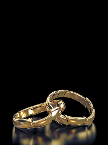 3d render of wedding rings shattering on a black background