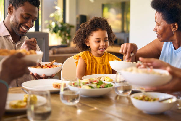 istock Multi-Generation Family Sitting Around Table Serving Food For Meal At Home 1483023752