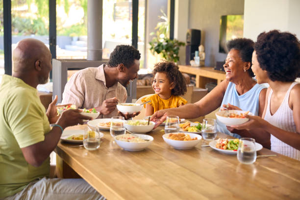 istock Multi-Generation Family Sitting Around Table Serving Food For Meal At Home 1483023889