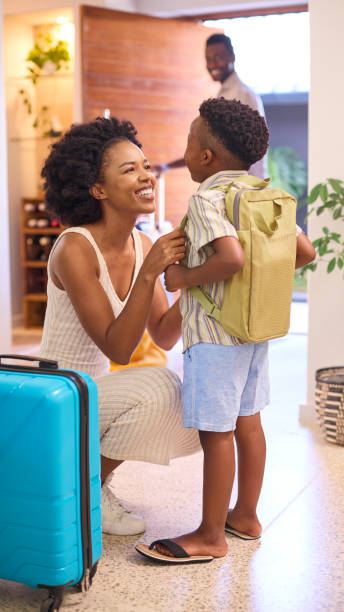 istock Mother Helping Son Get Ready With Backpack As Family Leave Home For Holiday Or Vacation 1483024776