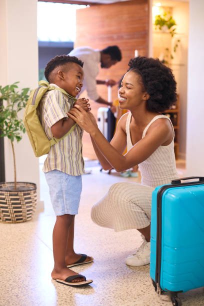 istock Mother Helping Son Get Ready With Backpack As Family Leave Home For Holiday Or Vacation 1483024794