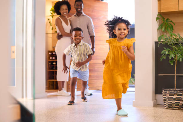 istock Family Returning Home Opening Front Door And Children Running In 1483024965