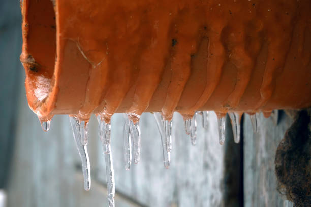istock A red sewer pipe and dangling frozen icicles. Icing on the pipe, after freezing rain 1483028185