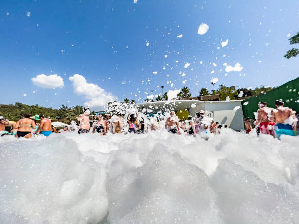 People enjoying outdoor foam party stock photo