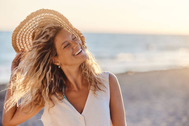 istock Cheerful woman with sun hat on the beach. 1483031835