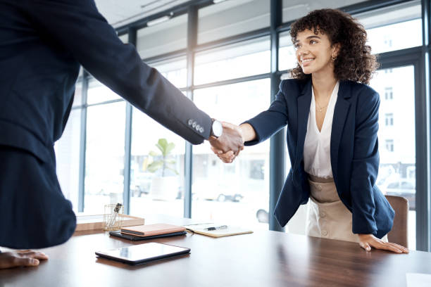 istock Business people, handshake and smile for b2b, interview or partnership in teamwork at the office. Happy female executive shaking hands with employee for meeting, greeting or introduction at workplace 1483032513