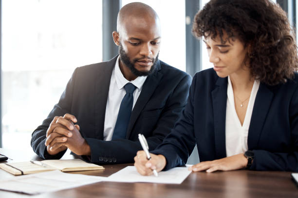 istock Documents, business and black people writing notes for accounting strategy, planning and company portfolio review. Teamwork, financial advisor and analysis of contract, investment or legal consulting 1483032857