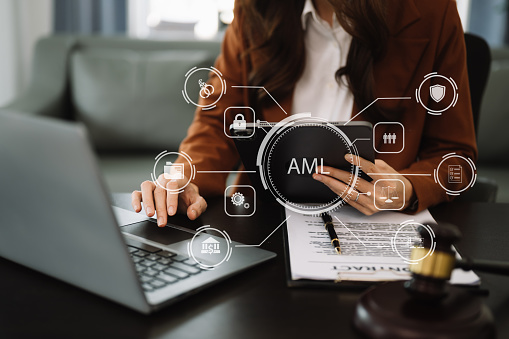 AML Anti Money Laundering Financial Bank Business Concept. judge in a courtroom using laptop and tablet with AML anti money laundering icon on virtual icon