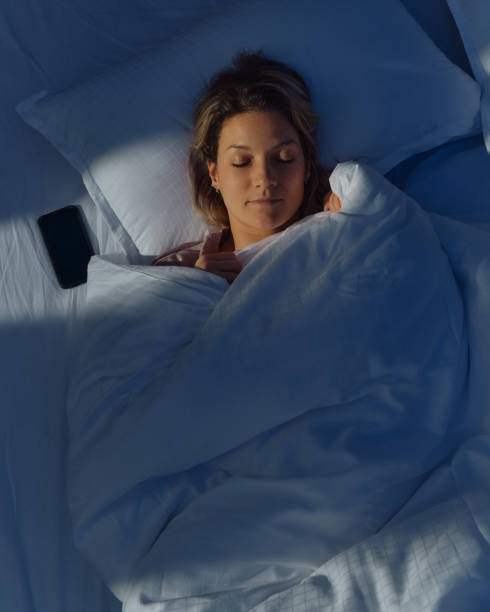 istock Above view of young relaxed woman sleeping in bed. 1483034122