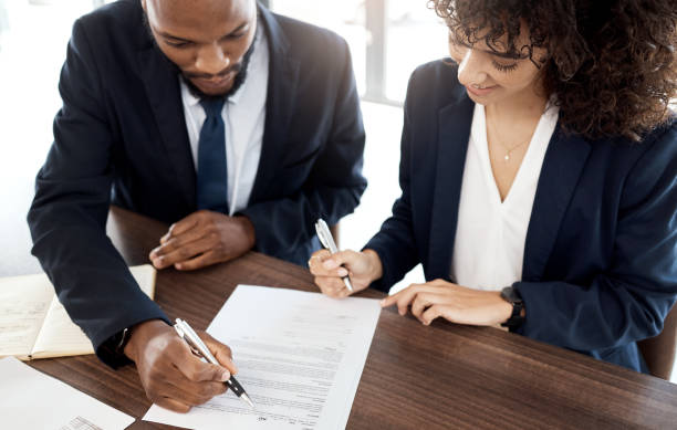 istock Top view, business team and people with contract, reading notes and planning company strategy. Teamwork, financial consulting and analysis of documents, investment or legal paperwork of office review 1483034126