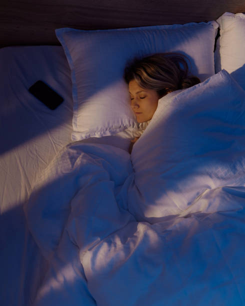 istock Above view of young woman sleeping in bed. 1483034326