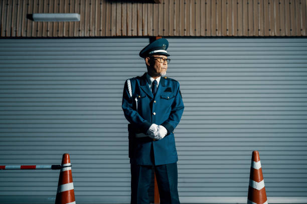 Senior male security guard on duty at night in Japan